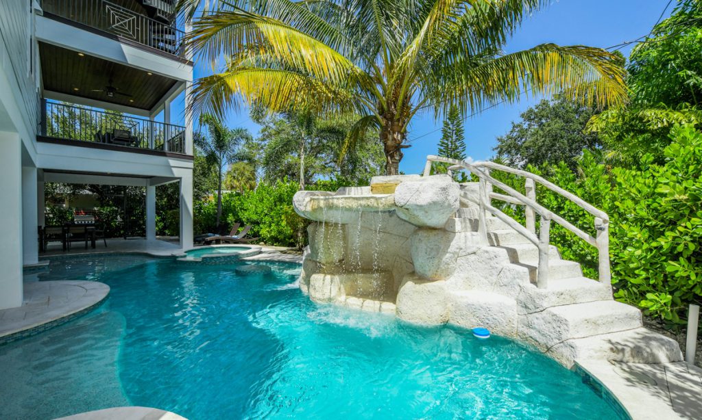 Island Sol vacation home with a tropical pool and waterfall feature on Anna Maria Island with AMI Locals